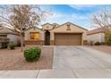 Attractive single-Gathering home showcasing a two-car garage, desert landscaping, and a well-maintained lawn at 2110 S 102Nd Ln, Tolleson, AZ 85353