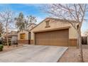 Well-kept home with a two-car garage, extended driveway, and minimal landscaping in a quiet neighborhood at 2110 S 102Nd Ln, Tolleson, AZ 85353