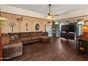 Inviting living room features a cozy brown sectional sofa and custom wall design at 2349 W Shaw Butte Dr, Phoenix, AZ 85029