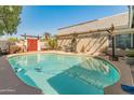 Backyard swimming pool with surrounding patio and pergola at 2349 W Shaw Butte Dr, Phoenix, AZ 85029