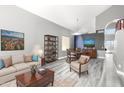 Open-concept living room featuring modern decor, a neutral color palette, and dining space at 2602 E Glass Ln, Phoenix, AZ 85042