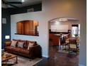 A living room area featuring a leather couch, decorated with pillows at 2901 W Straford Dr, Chandler, AZ 85224