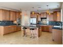 Spacious kitchen with custom cabinets, granite countertops, stainless steel appliances, and a center island at 3807 E Latham Ct, Gilbert, AZ 85297