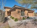 Attractive exterior elevation with desert landscaping, charming details, and attached garage at 41310 N Clear Crossing Ct, Anthem, AZ 85086