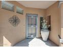 Inviting front porch with decorative metalwork and a view of the front entryway at 41310 N Clear Crossing Ct, Anthem, AZ 85086