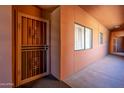 Hallway with a security door on a condo apartment with beige paint at 4303 E Cactus Rd # 308B, Phoenix, AZ 85032