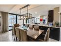Spacious dining area with a large table, modern chandelier, and views through expansive windows at 4808 N 24Th St # 1305, Phoenix, AZ 85016