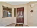 Inviting entrance to unit 431 with a rich, dark door, side window, and textured wall at 5104 N 32Nd St # 431, Phoenix, AZ 85018