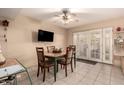 Cozy dining area with a ceiling fan, adjacent to the kitchen, and featuring sliding doors to the backyard at 5910 N 86Th St, Scottsdale, AZ 85250