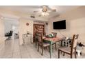 Cozy dining area with a ceiling fan, adjacent to the kitchen, and featuring a dining table and chairs at 5910 N 86Th St, Scottsdale, AZ 85250
