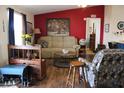 Cozy living room with a decorative red accent wall and comfortable furniture at 7807 E Main St # D-32, Mesa, AZ 85207