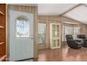 Inviting entryway with decorative glass door, wood paneling, and adjacent living area at 8103 E Southern Ave # 119, Mesa, AZ 85209