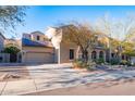 Charming two-story home featuring a three-car garage, desert landscaping, and a private driveway at 8362 W Rosewood Ln, Peoria, AZ 85383