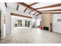 Bright living room with vaulted ceilings, exposed beams, tile floors and fireplace at 8742 E Via De La Luna --, Scottsdale, AZ 85258