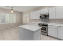 Bright kitchen featuring white cabinets, stainless steel appliances, and a center island at 896 E Indian Wells Pl, Chandler, AZ 85249
