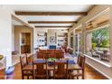 Open-concept living and dining area with hardwood floors, fireplace, and built-in shelving at 9671 E Cavalry Dr, Scottsdale, AZ 85262