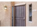 Close-up of the front door featuring a security screen, outdoor light, and unit number at 10410 N Cave Creek Rd # 2114, Phoenix, AZ 85020