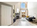 Open living room with vaulted ceilings, wood floors, fireplace, and access to balcony at 10410 N Cave Creek Rd # 2114, Phoenix, AZ 85020