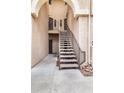 Exterior staircase leading to the units with covered archway and neutral color scheme at 10410 N Cave Creek Rd # 2114, Phoenix, AZ 85020