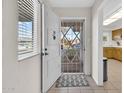 Inviting entryway featuring a white security door and a view of the kitchen at 10414 N 105Th Ave, Sun City, AZ 85351