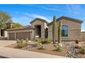 Stunning home exterior with a three car garage and desert landscaping at 10819 E Butherus Drive --, Scottsdale, AZ 85255