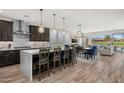 Bright kitchen showcasing a large island, modern appliances, and seamless flow into the dining and living areas with outdoor views at 11172 N San Clemente St, Surprise, AZ 85388