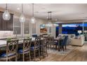 Bright, open kitchen featuring a large island with pendant lighting, modern appliances, and seamless flow into the living area at 11172 N San Clemente St, Surprise, AZ 85388