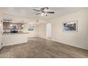 Open living area featuring tile flooring, a ceiling fan, and an adjacent kitchen at 1125 E Broadway Rd # 102, Tempe, AZ 85282