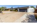 Exterior home with a long driveway, basketball hoop, pergola, and desert landscaping at 13201 N 24Th Ave, Phoenix, AZ 85029