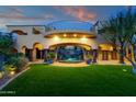 Lush backyard featuring a flowing waterfall feature, manicured lawn and desert landscaping at 14675 E Paradise Dr, Fountain Hills, AZ 85268
