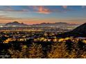 Beautiful desert property view of city lights and rolling hills with the setting sun in the sky at 14675 E Paradise Dr, Fountain Hills, AZ 85268