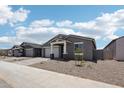 Charming single-story home with a two-car garage and neutral-toned exterior at 15769 W Beryl Ave, Waddell, AZ 85355