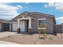 Charming single-story home with a two-car garage and neutral-toned exterior at 15769 W Beryl Ave, Waddell, AZ 85355