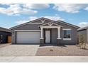 Charming single-story home with a two-car garage and neutral-toned exterior at 15769 W Beryl Ave, Waddell, AZ 85355