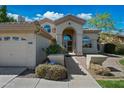 Inviting front entrance with decorative windows, an arched doorway, and manicured landscaping at 16018 N 17Th Way, Phoenix, AZ 85022