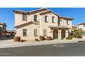 Inviting two-story home with manicured landscaping, arched entry, and classic architectural details at 16610 W Culver St, Goodyear, AZ 85338