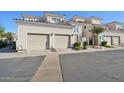 Condo featuring a two-car garage and well-kept landscaping at 1747 E Northern E Ave # 166, Phoenix, AZ 85020