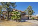Inviting two-story house with a two-car garage, complemented by palm trees and a basketball hoop at 18194 N 59Th Ln, Glendale, AZ 85308