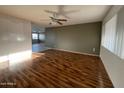 A large living room with wood laminate flooring and neutral colored walls at 18221 N 56Th Ln, Glendale, AZ 85308