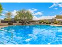 Sparkling community pool with clear blue water, sunshades, and ample space for lounging and relaxation at 2048 W Elm St, Phoenix, AZ 85015