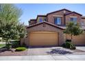 Beautiful two-story home featuring a tan exterior, red tile roof, and a spacious two-car garage at 250 W Queen Creek Rd # 229, Chandler, AZ 85248