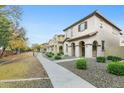 Tan-colored two-story home featuring a red tiled roof and well-maintained landscaping at 25824 N 54Th Ave, Phoenix, AZ 85083
