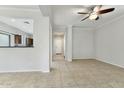 A view of the open-concept living room with tile flooring and a ceiling fan at 25824 N 54Th Ave, Phoenix, AZ 85083