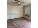 Bedroom featuring tile flooring, a ceiling fan, and a bright window at 2912 E Monroe St, Phoenix, AZ 85034