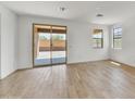 Bright, open living area with tile flooring, sliding glass doors, and ample natural light at 31783 N 130Th Ave, Peoria, AZ 85383