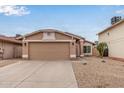 Charming single-level home featuring a two-car garage, desert landscaping, and neutral color palette at 3613 W Camino Real --, Glendale, AZ 85310