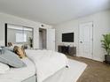 Bright bedroom featuring a plush bed, mirrored closet doors, and a view to a lovely outside at 3825 E Camelback Rd # 292, Phoenix, AZ 85018