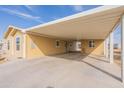 Spacious carport for single-story home leads to front door entrance at 40569 N Wedge Dr, San Tan Valley, AZ 85140