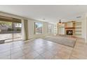 Spacious living room with fireplace and large sliding doors, offering abundant natural light at 42209 N 46Th Ln, Phoenix, AZ 85086