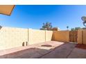 Enclosed backyard featuring a brick paver patio area and block wall for privacy at 4650 E Wood St, Phoenix, AZ 85040